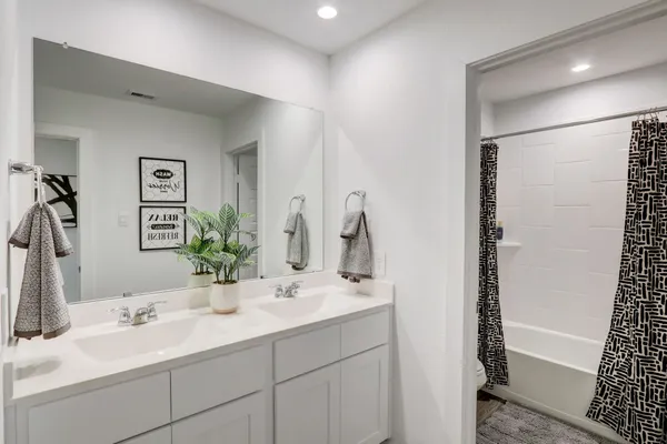 a bathroom with a double vanity sink and a mirror
