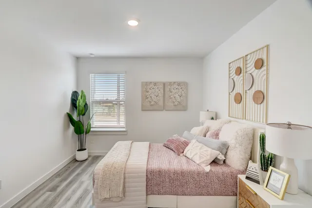 a bedroom with a bed and a window