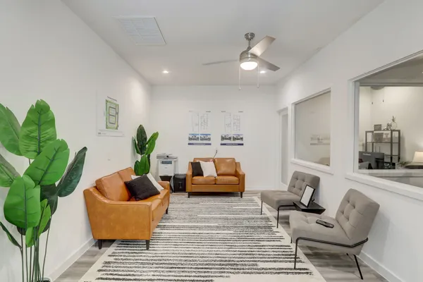 a living room with furniture and a potted plant