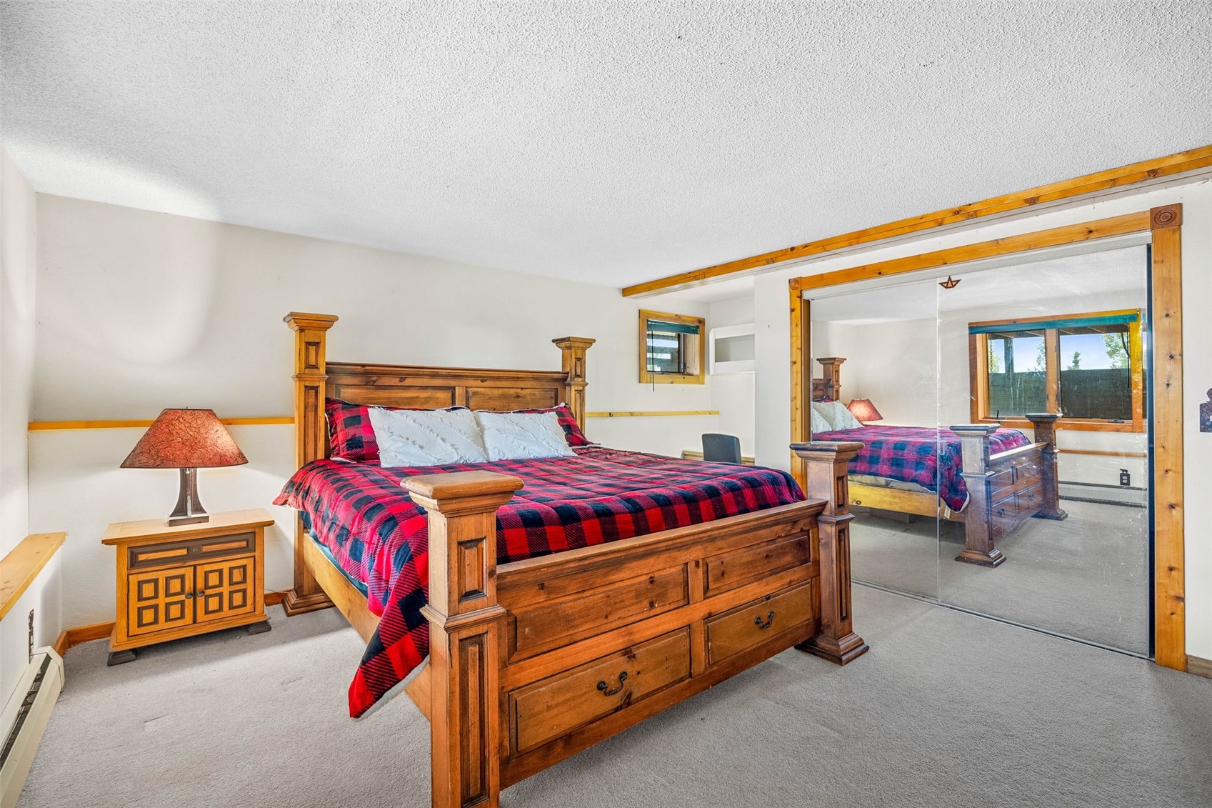 597 Sheep Ridge Road Fairplay, CO 80440 - Photo 35 of 50 a bedroom with a bed and a lamp