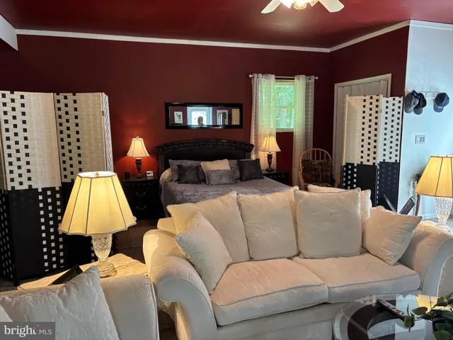a living room with furniture and a lamp