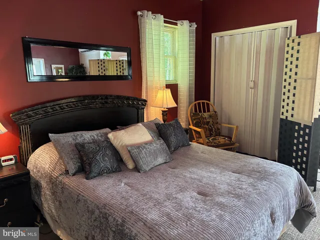 a bedroom with bed and window