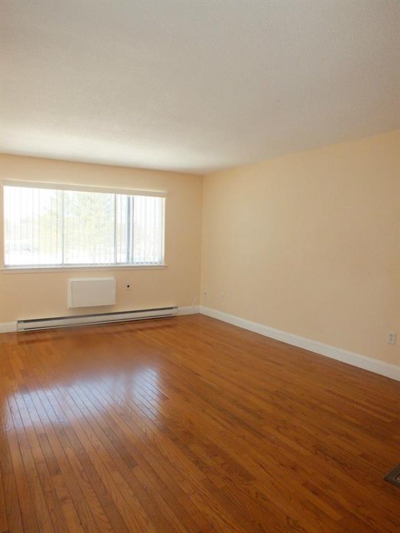 93 Kent Court, Unit 93 Meriden, CT 06450 - Photo 9 of 27 an empty room with wooden floor and windows
