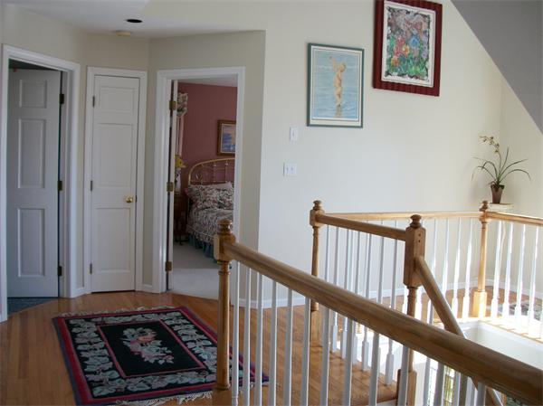 23 Elliott Road Sterling, MA 01564 - Photo 17 of 30 a view of a hallway to a livingroom with wooden floor and furniture