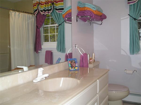 23 Elliott Road Sterling, MA 01564 - Photo 25 of 30 a bathroom with a sink vanity mirror and toilet