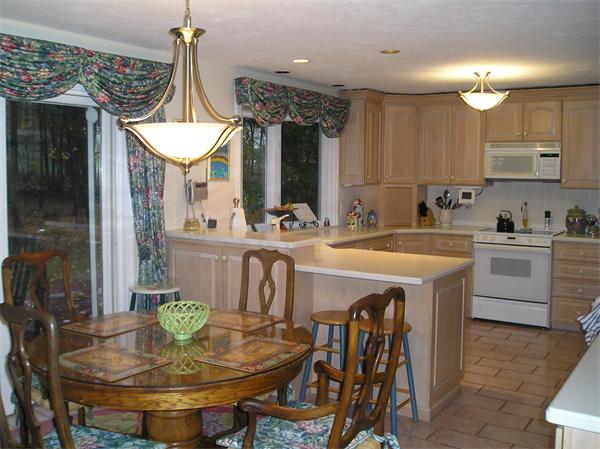 23 Elliott Road Sterling, MA 01564 - Photo 9 of 30 a kitchen with stainless steel appliances granite countertop a sink a stove and chairs