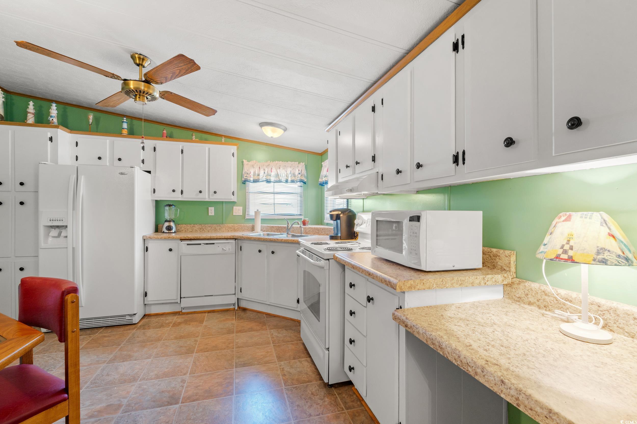 976 South Marlin Circle Murrells Inlet, SC 29576 - Photo 12 of 36 Kitchen with light countertops, vaulted ceiling, a