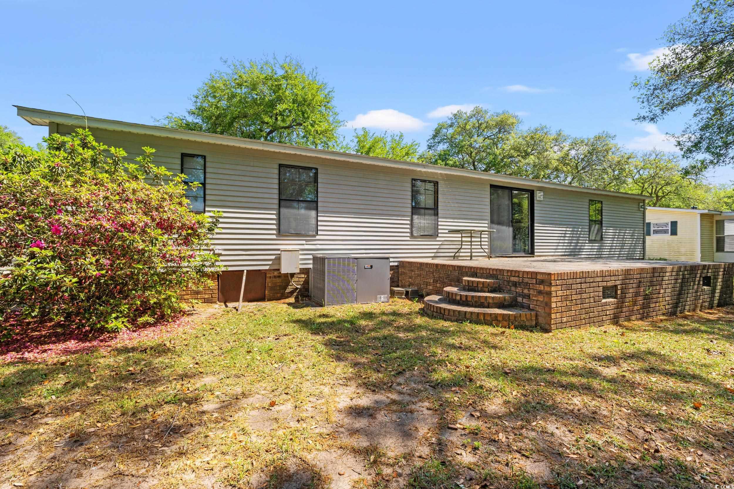 976 South Marlin Circle Murrells Inlet, SC 29576 - Photo 31 of 36 Back of house featuring a patio area, a lawn, and
