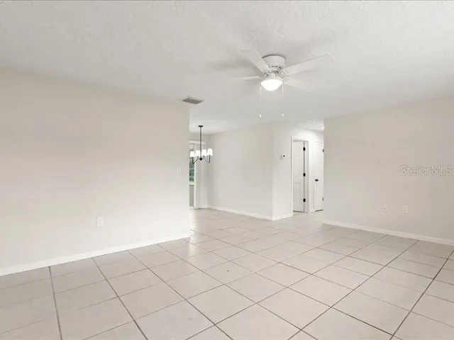 an empty room with fan and fan