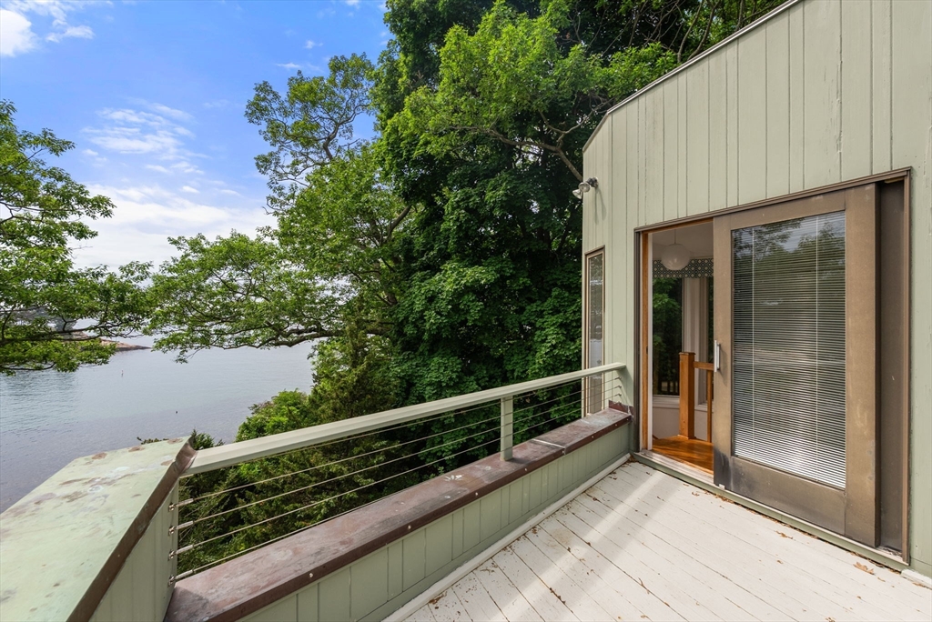 23 Ocean Street Manchester, MA 01944 - Photo 22 of 36 a view of balcony with wooden floor and lake view