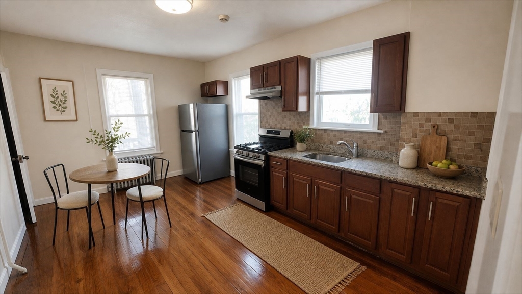35 Catawba Street, Unit 2 Boston, MA 02119 - Photo 3 of 15 a kitchen with stainless steel appliances granite countertop wooden floors a stove and a refrigerator