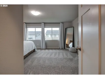 a bedroom with a large bed and a large window