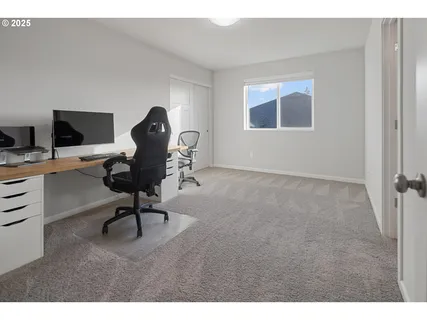 a view of a backyard with furniture and a garden