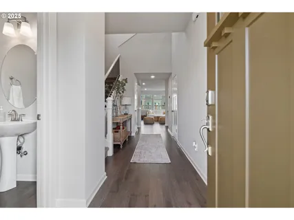 a view of a hallway with wooden floor and furniture