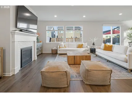 a living room with furniture wooden floor and a fireplace