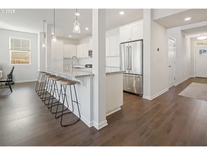 a large kitchen with kitchen island a sink stainless steel appliances and cabinets