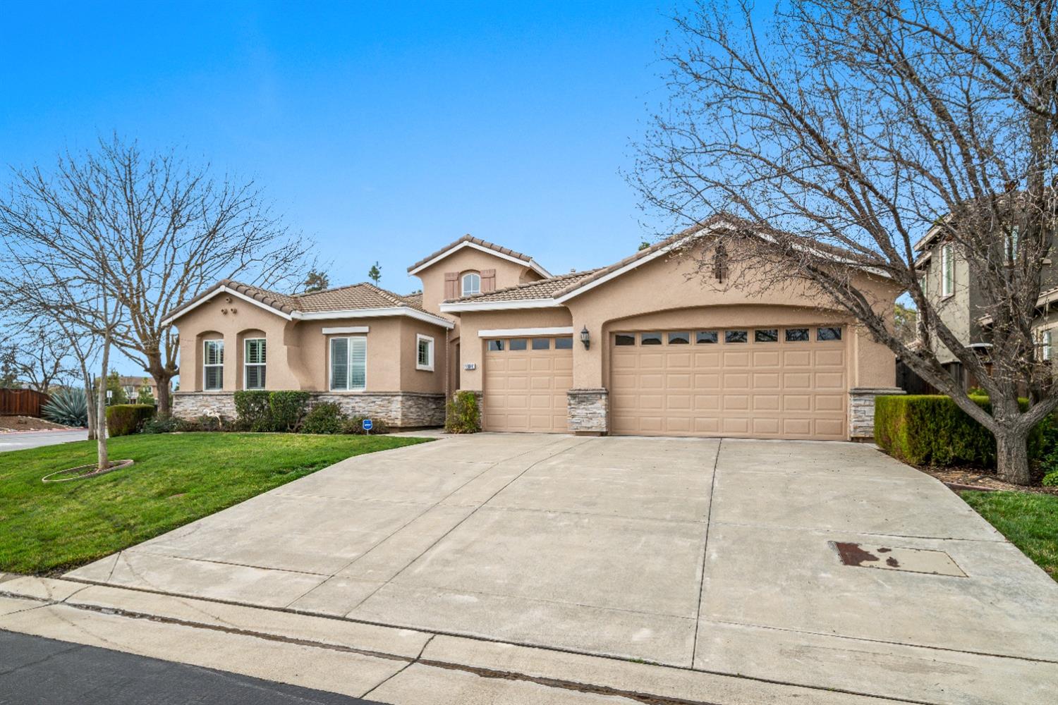 a front view of a house with a yard and garage