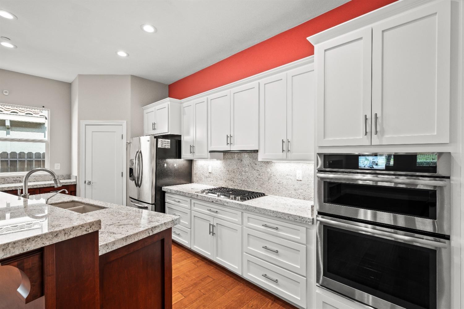 18040 Ruddy Street Woodland, CA 95695 - Photo 11 of 40 a kitchen with granite countertop a sink stainless steel appliances and cabinets