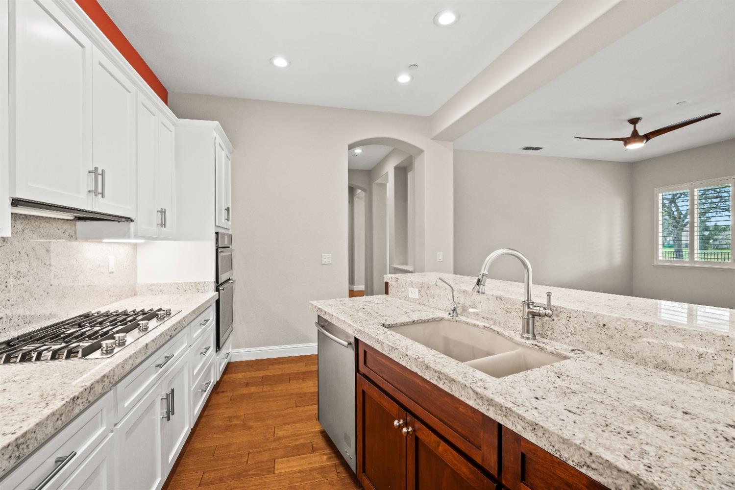 18040 Ruddy Street Woodland, CA 95695 - Photo 12 of 40 a kitchen with granite countertop a sink stove and cabinets