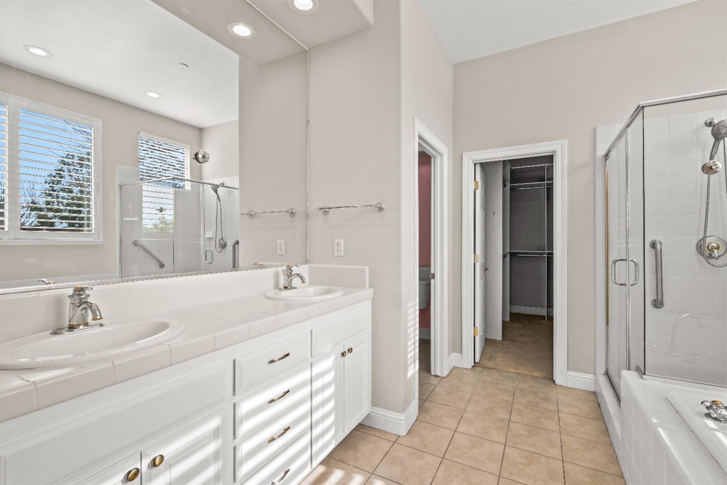 18040 Ruddy Street Woodland, CA 95695 - Photo 20 of 40 a spacious bathroom with a double vanity sink a mirror and a shower