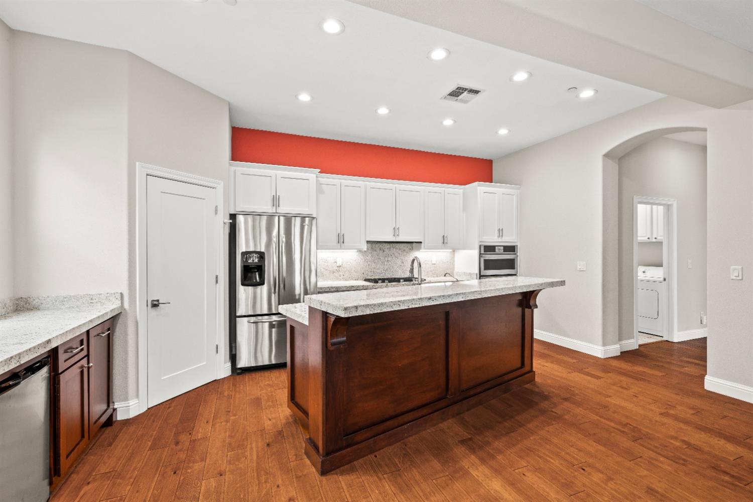 18040 Ruddy Street Woodland, CA 95695 - Photo 10 of 40 a kitchen with stainless steel appliances granite countertop a sink a stove a refrigerator and island with wooden floor