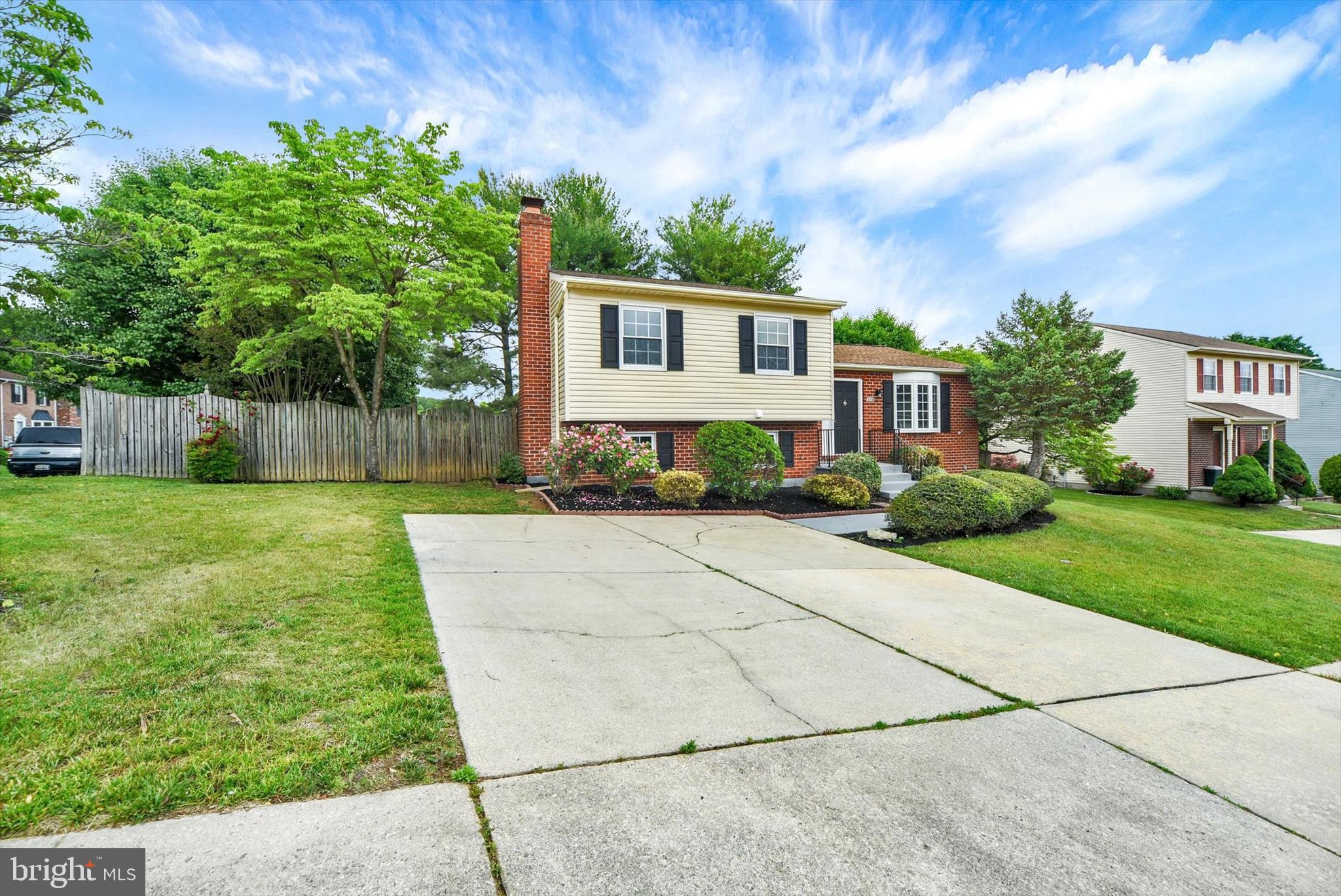 3808 Perryhurst Place Baltimore, MD 21236 - Photo 5 of 29 a front view of a house with a yard and potted plants