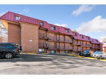 a vase of flowers sitting on a wooden floor