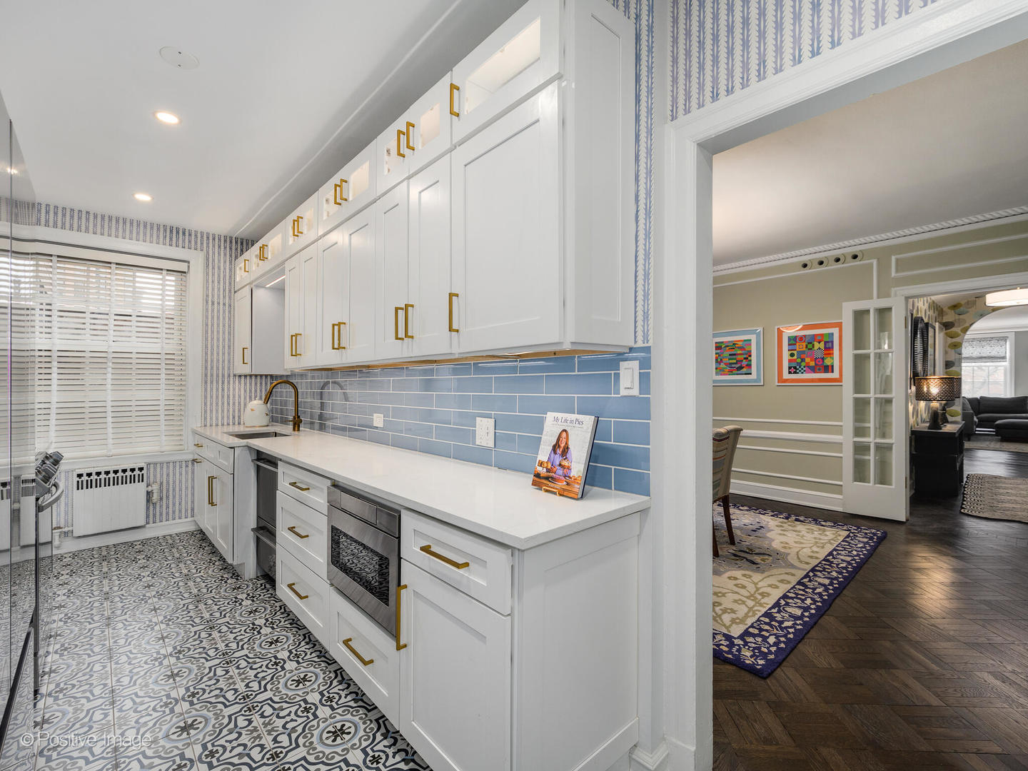 73 East Elm Street, Unit 4B Chicago, IL 60611 - Photo 13 of 27 a kitchen with stainless steel appliances cabinets a sink and a wooden floor