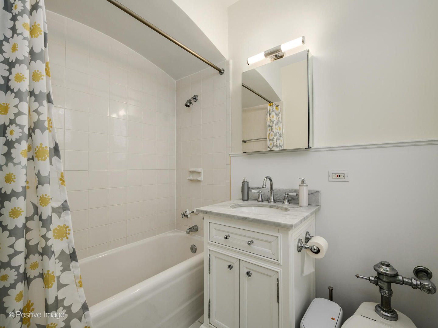73 East Elm Street, Unit 4B Chicago, IL 60611 - Photo 18 of 27 a bathroom with a bathtub sink vanity mirror and toilet