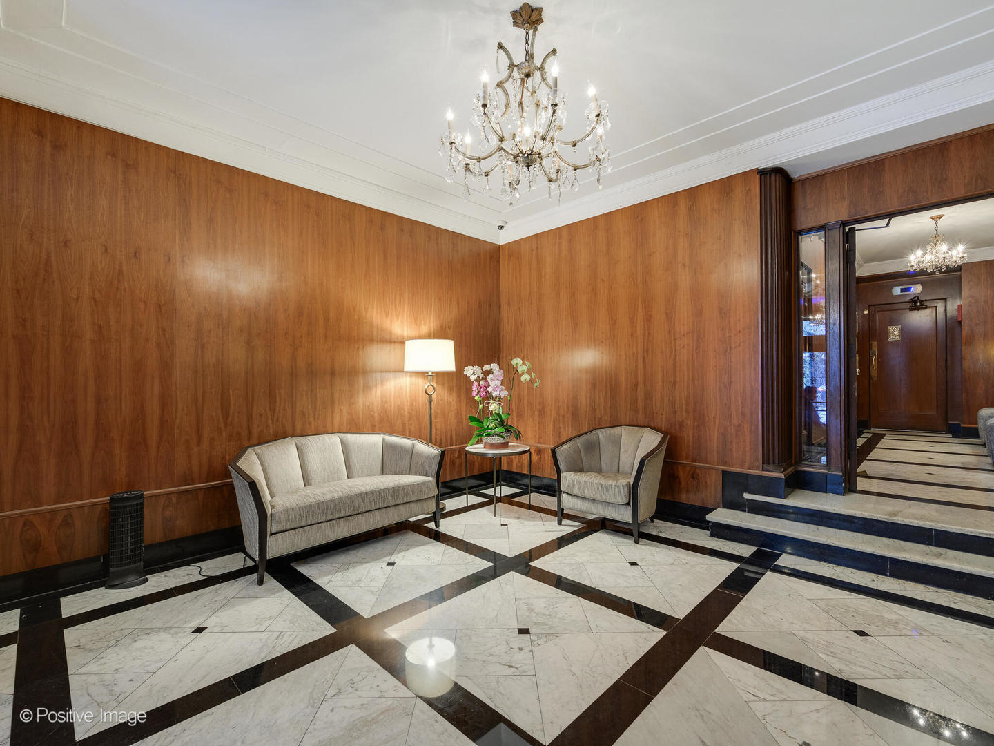 73 East Elm Street, Unit 4B Chicago, IL 60611 - Photo 26 of 27 a living room with furniture and a chandelier