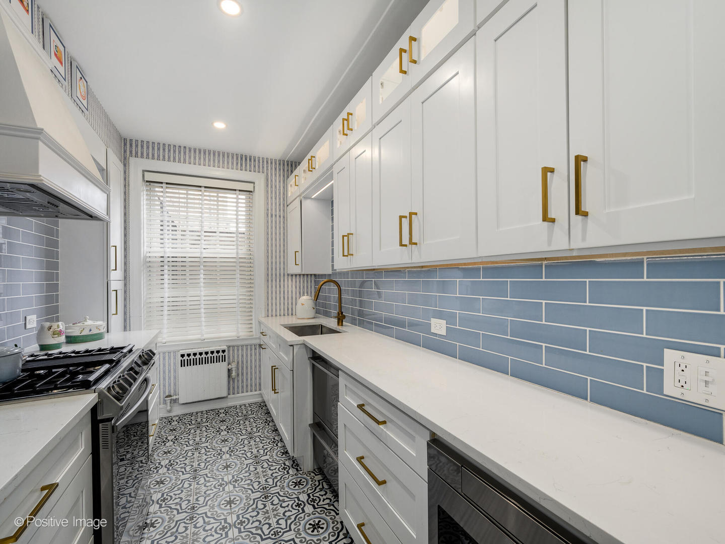 73 East Elm Street, Unit 4B Chicago, IL 60611 - Photo 10 of 27 a kitchen with a sink stove and cabinets