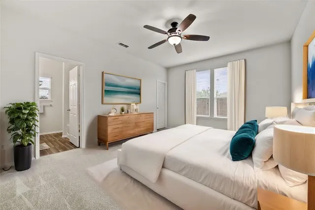 a bedroom with a bed a chandelier and a couch