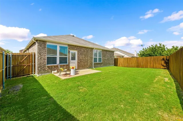 a view of a house with backyard porch and garden