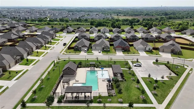 an aerial view of multiple houses with yard