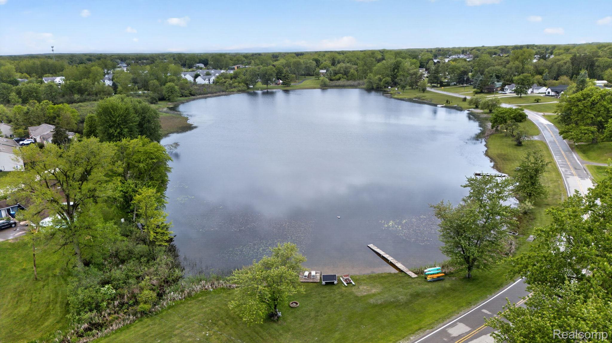 1280 Petts Road Fenton, MI 48430 - Photo 5 of 62 Bird's eye view of a large body of water and a tree filled landscape