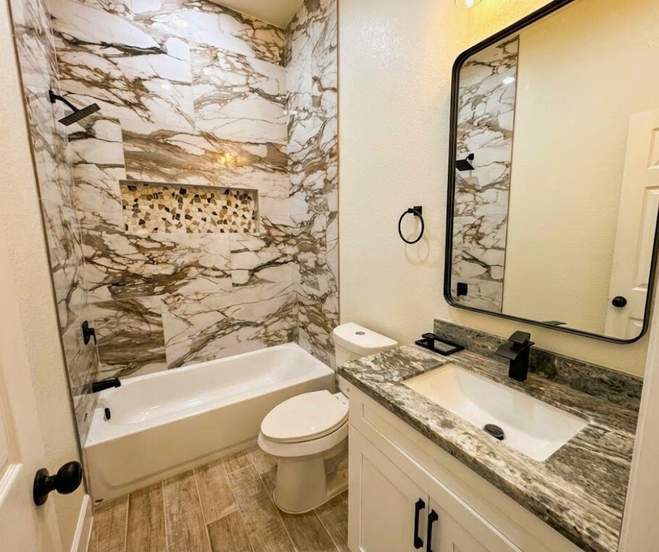 107 County Road 3372 Cleveland, TX 77327 - Photo 19 of 27 a bathroom with a granite countertop sink toilet and shower