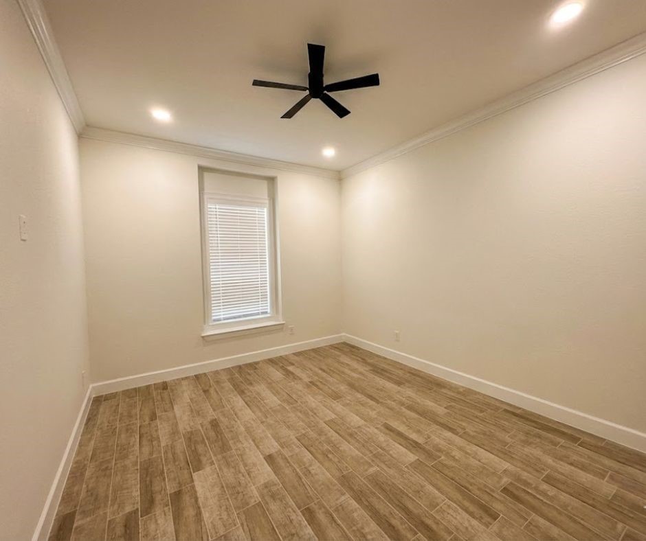 107 County Road 3372 Cleveland, TX 77327 - Photo 22 of 27 wooden floor in an empty room with a window