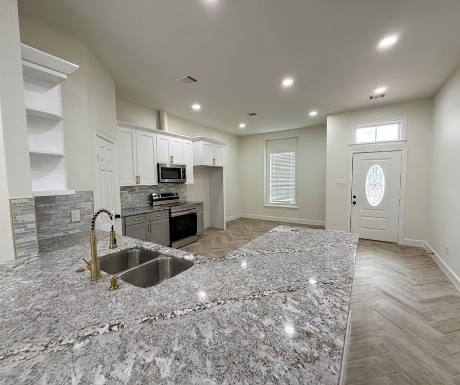 107 County Road 3372 Cleveland, TX 77327 - Photo 5 of 27 a kitchen with stainless steel appliances granite countertop a sink stove and refrigerator