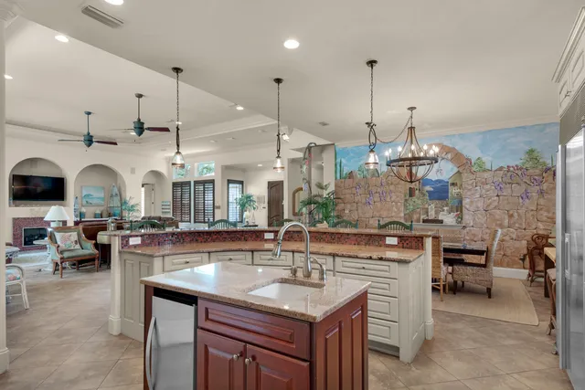 a bedroom with a large bed and a chandelier