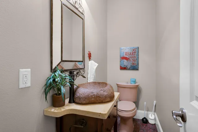 a view of swimming pool with lawn chairs and plants