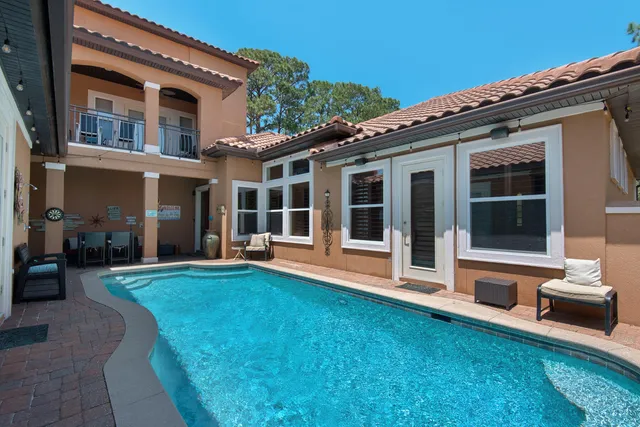 a living room with furniture large window and outdoor view