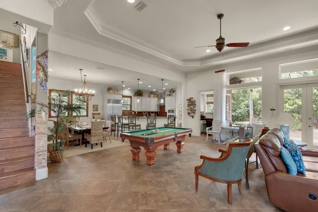a living room with furniture a fireplace and a large window