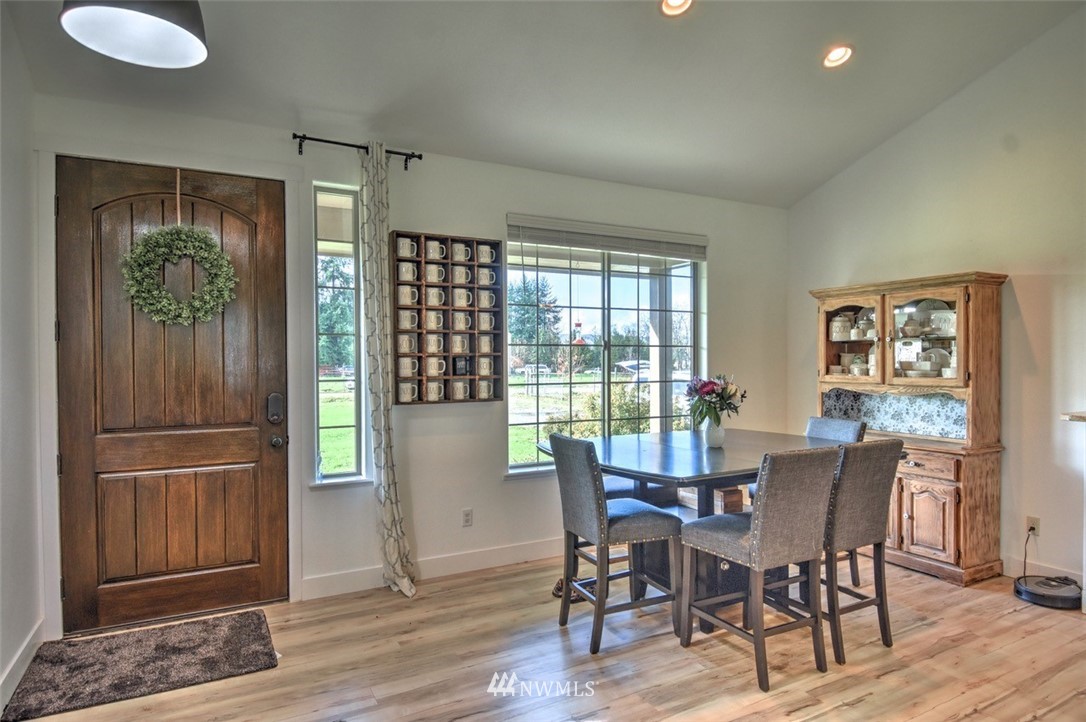 8637 183rd Avenue Southwest Rochester, WA 98579 - Photo 12 of 33 a view of a dining room with furniture and wooden floor