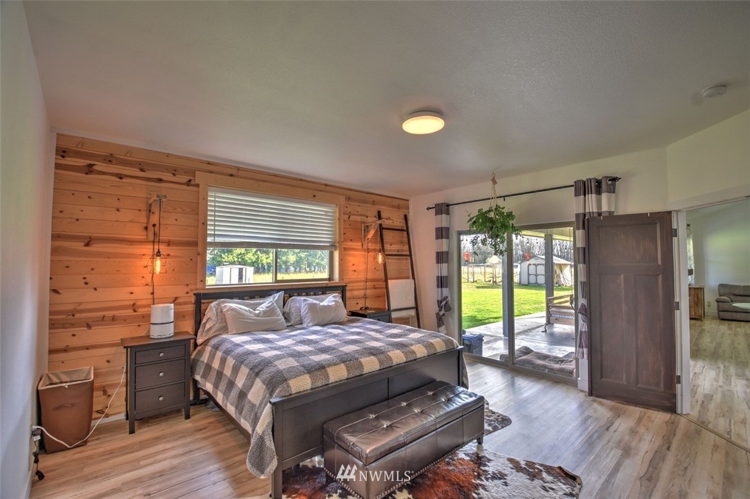8637 183rd Avenue Southwest Rochester, WA 98579 - Photo 13 of 33 a bed sitting in a bedroom next to a window