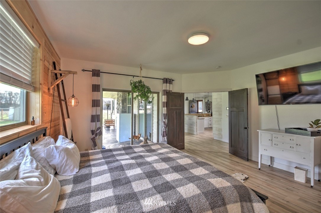 8637 183rd Avenue Southwest Rochester, WA 98579 - Photo 15 of 33 a spacious bedroom with a bed and glass walk in closet