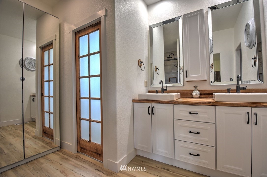 8637 183rd Avenue Southwest Rochester, WA 98579 - Photo 17 of 33 a bathroom with double vanity sink a mirror and a bathtub