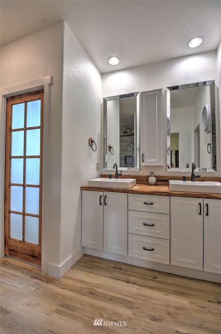 8637 183rd Avenue Southwest Rochester, WA 98579 - Photo 18 of 33 a bathroom with a sink double vanity and a mirror