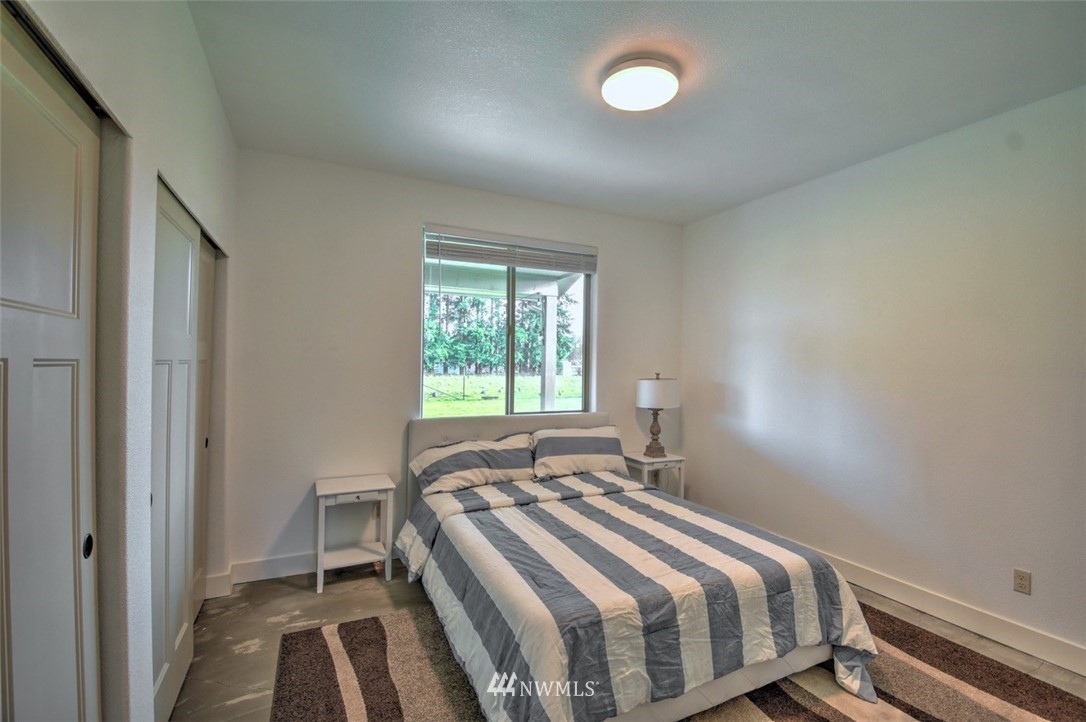 8637 183rd Avenue Southwest Rochester, WA 98579 - Photo 20 of 33 a bedroom with a bed and a window