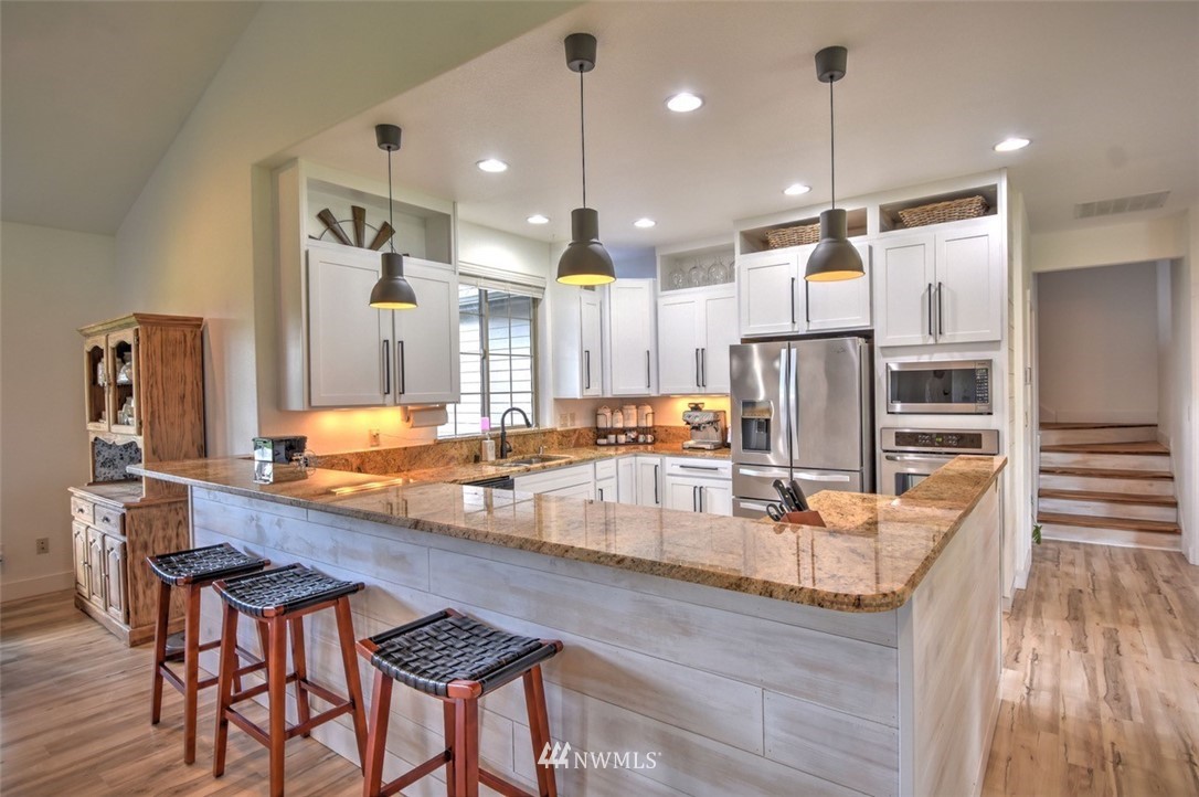 8637 183rd Avenue Southwest Rochester, WA 98579 - Photo 3 of 33 a large kitchen with a table and chairs