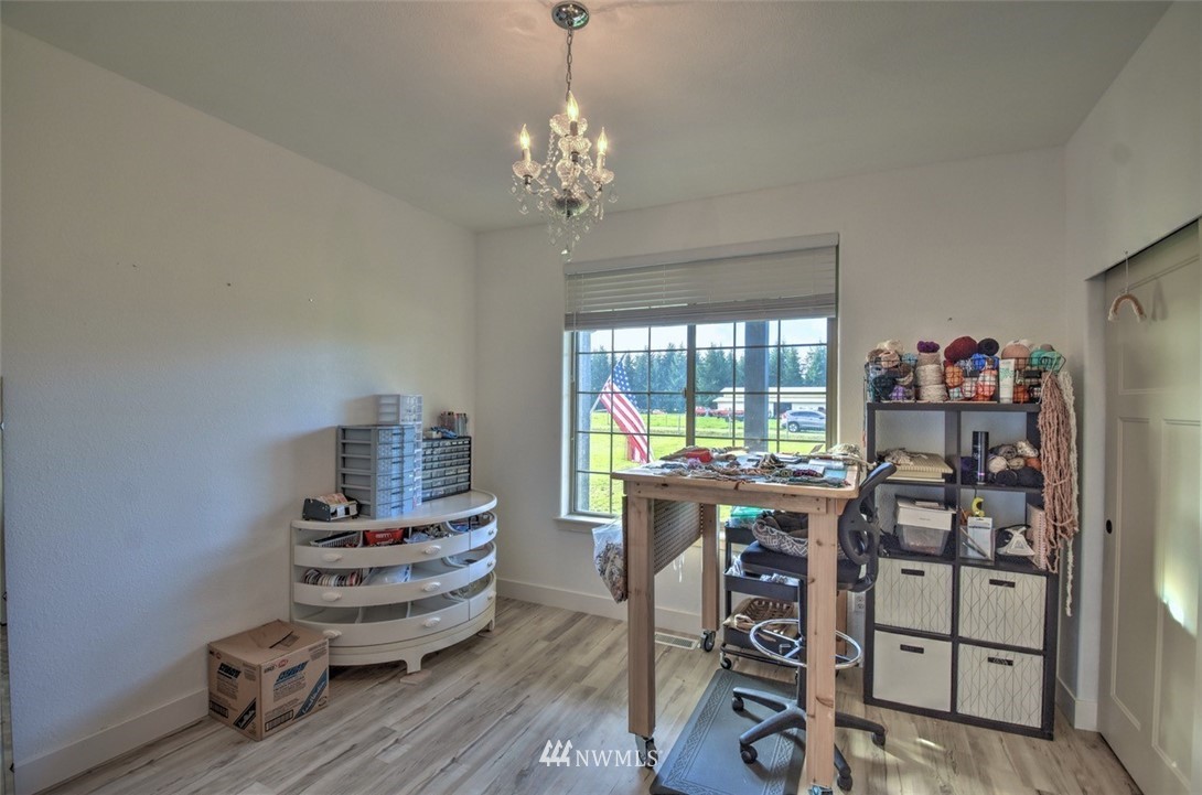 8637 183rd Avenue Southwest Rochester, WA 98579 - Photo 21 of 33 a view of a workspace with furniture and a chandelier